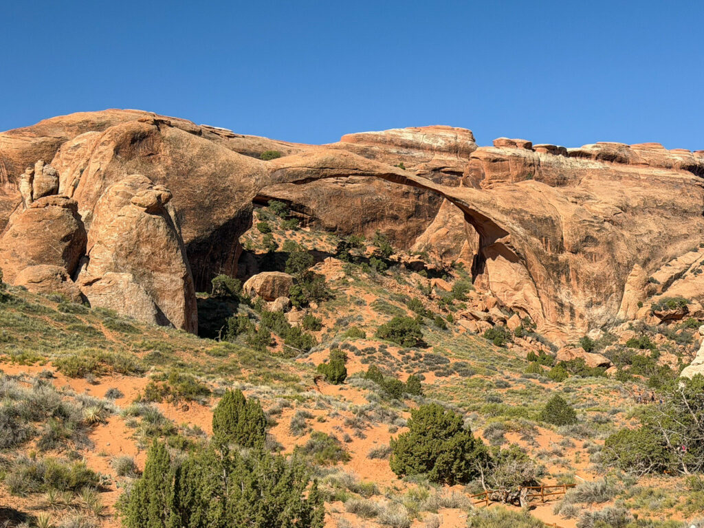 Landscape Arch's remarkably thin sandstone span stretches across the sky above the Devils Garden Trail in Arches National Park.