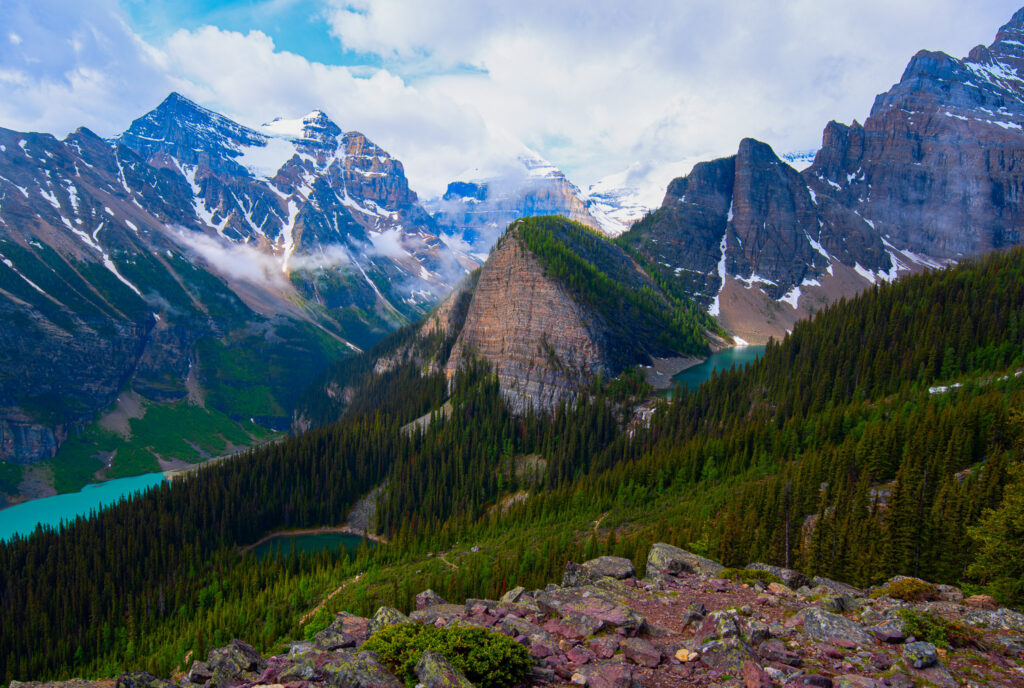 Lake Louise, Mirror Lake, and Lake Agnes all visible from the summit of the Little Beehive Trail with turquoise water and snow-dusted summits