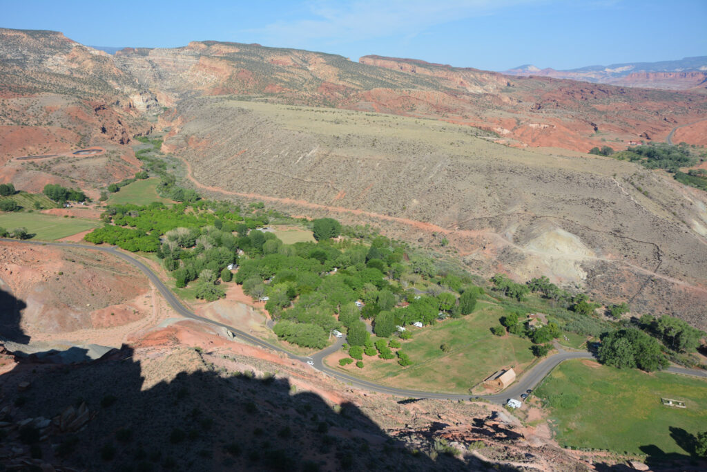View from top of switchbacks on Capitol Reef's Cohab Canyon trail, looking down onto the Fruita historic district